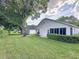 Lush green backyard with mature trees providing shade and privacy at 3827 Westerham Dr, Clermont, FL 34711