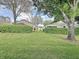 Lush green backyard featuring a well-maintained lawn and privacy hedges at 3827 Westerham Dr, Clermont, FL 34711