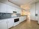 Functional kitchen layout with tile floors, white cabinets, and modern appliances at 3827 Westerham Dr, Clermont, FL 34711