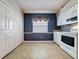 Cozy kitchen dining area with tiled floors, ample storage, and a large window at 3827 Westerham Dr, Clermont, FL 34711