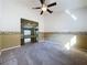 Living Room with carpeted floors, fan, and is open to the kitchen at 3827 Westerham Dr, Clermont, FL 34711