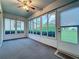 Bright sunroom with many windows providing natural light and backyard views at 3827 Westerham Dr, Clermont, FL 34711