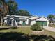 Single story home featuring a brick paved driveway, lush lawn, and covered porch at 4344 River Ridge Dr, Leesburg, FL 34748