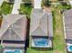 An aerial view shows the home's backyard with screened pool and roof at 4703 Golden Beach Ct, Kissimmee, FL 34746