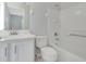 A bathroom featuring a toilet, bathtub, shower, and white vanity at 4703 Golden Beach Ct, Kissimmee, FL 34746