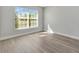 Inviting bedroom with light laminate flooring and a bright window at 4703 Golden Beach Ct, Kissimmee, FL 34746