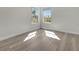 Bright bedroom featuring light wood floors and two windows at 4703 Golden Beach Ct, Kissimmee, FL 34746