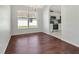 Dining room area with hardwood floors, view of the kitchen, and a large window at 4703 Golden Beach Ct, Kissimmee, FL 34746