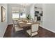 A dining room featuring a wooden table and chairs, chandelier, and view of the kitchen at 4703 Golden Beach Ct, Kissimmee, FL 34746