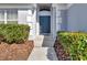 Inviting front entrance framed by green bushes and an arched front door at 4703 Golden Beach Ct, Kissimmee, FL 34746