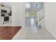 Bright hallway with views of the kitchen, staircase, and a large picture window at 4703 Golden Beach Ct, Kissimmee, FL 34746