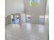 View of the light-filled living room with high ceilings and sliding glass doors to the outdoors at 4703 Golden Beach Ct, Kissimmee, FL 34746