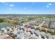 Community aerial view showcasing the golf course and water amenities with surrounding residential area at 5829 Tupelo Ter, The Villages, FL 32163