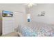 Comfortable bedroom with a closet, dresser, and a view into the living area for seamless entertaining at 5829 Tupelo Ter, The Villages, FL 32163