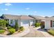 Charming single-story home featuring a two-car garage and a beautifully landscaped front yard at 5829 Tupelo Ter, The Villages, FL 32163
