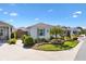 Well-maintained front yard with lush landscaping and a paved walkway leading to the entrance at 5829 Tupelo Ter, The Villages, FL 32163