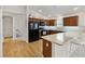 Spacious kitchen with modern black appliances, light countertops, and stylish backsplash, leading to the rest of the home at 5829 Tupelo Ter, The Villages, FL 32163