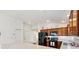 Modern kitchen featuring a breakfast bar, dark wood cabinets, stainless steel appliances, and light countertops at 5829 Tupelo Ter, The Villages, FL 32163