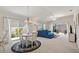 Bright and airy living room with natural light, white furniture, and a view of the backyard and patio at 5829 Tupelo Ter, The Villages, FL 32163