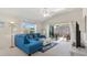 Comfortable living room with vaulted ceilings, large windows, and a sliding glass door to the screened-in lanai at 5829 Tupelo Ter, The Villages, FL 32163