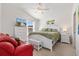 Inviting main bedroom with vaulted ceilings, a large window, and a comfortable queen-sized bed and decor at 5829 Tupelo Ter, The Villages, FL 32163