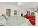 Spacious main bedroom boasts vaulted ceilings, a private lanai entrance, and a comfortable seating area at 5829 Tupelo Ter, The Villages, FL 32163
