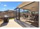 Exterior view from the yard of the home's screened-in patio with outdoor furniture and grill at 5829 Tupelo Ter, The Villages, FL 32163