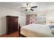 Comfortable bedroom with hardwood floors, an armoire, and closet at 604 Juanita Ct, The Villages, FL 32159
