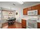 Bright dining area featuring a decorative light fixture and built-in kitchen cabinetry at 604 Juanita Ct, The Villages, FL 32159