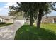 Charming home with well-maintained lawn and an attached garage with a long driveway at 604 Juanita Ct, The Villages, FL 32159
