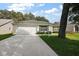 Charming home with a well-maintained lawn, an attached garage, and a long driveway at 604 Juanita Ct, The Villages, FL 32159