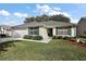 Well-kept home with attached garage, manicured lawn, complemented by tasteful landscaping at 604 Juanita Ct, The Villages, FL 32159
