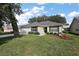 Charming single-story home featuring a manicured lawn and an attached two-car garage at 604 Juanita Ct, The Villages, FL 32159
