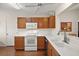 Bright kitchen with oak cabinets, stainless appliances, and a view to the dining area at 604 Juanita Ct, The Villages, FL 32159