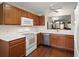 Bright kitchen with white countertops, stainless steel appliances, and wood cabinets at 604 Juanita Ct, The Villages, FL 32159