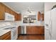 Well-lit kitchen featuring stainless steel appliances, wood cabinets, and a passthrough window at 604 Juanita Ct, The Villages, FL 32159