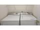 Efficient laundry room with side by side washer and dryer at 604 Juanita Ct, The Villages, FL 32159