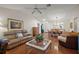 Bright open living room with hardwood floors with connection to the dining room at 604 Juanita Ct, The Villages, FL 32159