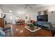 Open living area with hardwood floors connecting living room and dining room at 604 Juanita Ct, The Villages, FL 32159