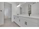 Modern bathroom featuring double vanity with white cabinetry, quartz countertop, and black hardware and faucet at 6553 Rover Way, St Cloud, FL 34771