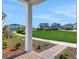 View from the porch looking out at the green lawn and community homes at 6553 Rover Way, St Cloud, FL 34771