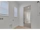 Laundry room with wood-look flooring, two windows, and utility connections at 6553 Rover Way, St Cloud, FL 34771