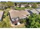 Birds eye showing backyard patio, neighborhood street, and mature trees surrounding the house at 7650 Se 174Th Gaillard Pl, The Villages, FL 32162