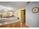 Bright kitchen area featuring a breakfast bar and an open view to the living room at 7650 Se 174Th Gaillard Pl, The Villages, FL 32162