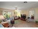 Comfortable living room with tile flooring, ceiling fan, and sliding doors to the outdoor patio at 7650 Se 174Th Gaillard Pl, The Villages, FL 32162