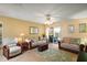 Bright living room featuring tile floors, two sofas, and glass doors to the porch at 7650 Se 174Th Gaillard Pl, The Villages, FL 32162