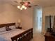 Bedroom featuring carpet, ceiling fan, and natural light with en-suite bathroom and walk-in closet at 8165 Bridgeport Bay Cir, Mount Dora, FL 32757