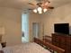 Bedroom featuring carpet, ceiling fan, a walk-in closet, and a view of the bathroom at 8165 Bridgeport Bay Cir, Mount Dora, FL 32757