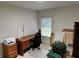 Bedroom featuring a desk, chair, and window with blinds at 8165 Bridgeport Bay Cir, Mount Dora, FL 32757