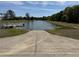 Community boat ramp and dock on a serene lake with lush green banks at 8165 Bridgeport Bay Cir, Mount Dora, FL 32757